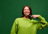 lifestyle woman brushing with black boost brush